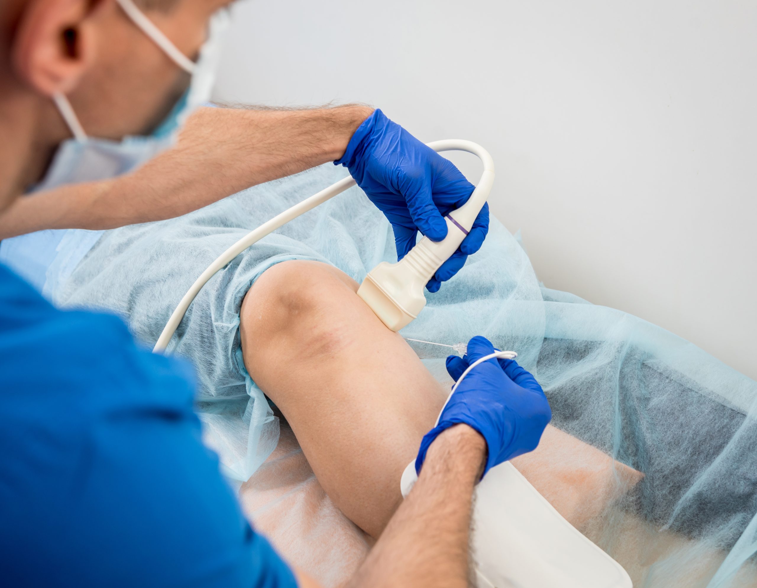 Image of a doctor performing radiofrequency lesioning on someone with knee pain